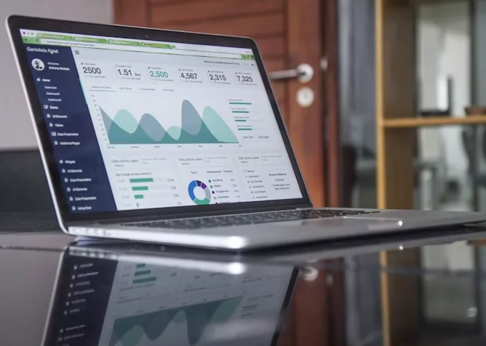 Laptop displaying business charts and an analytics dashboard