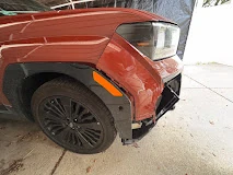 Red pickup truck with damage around the front bumper and fender in the All Cars Auto Service gallery