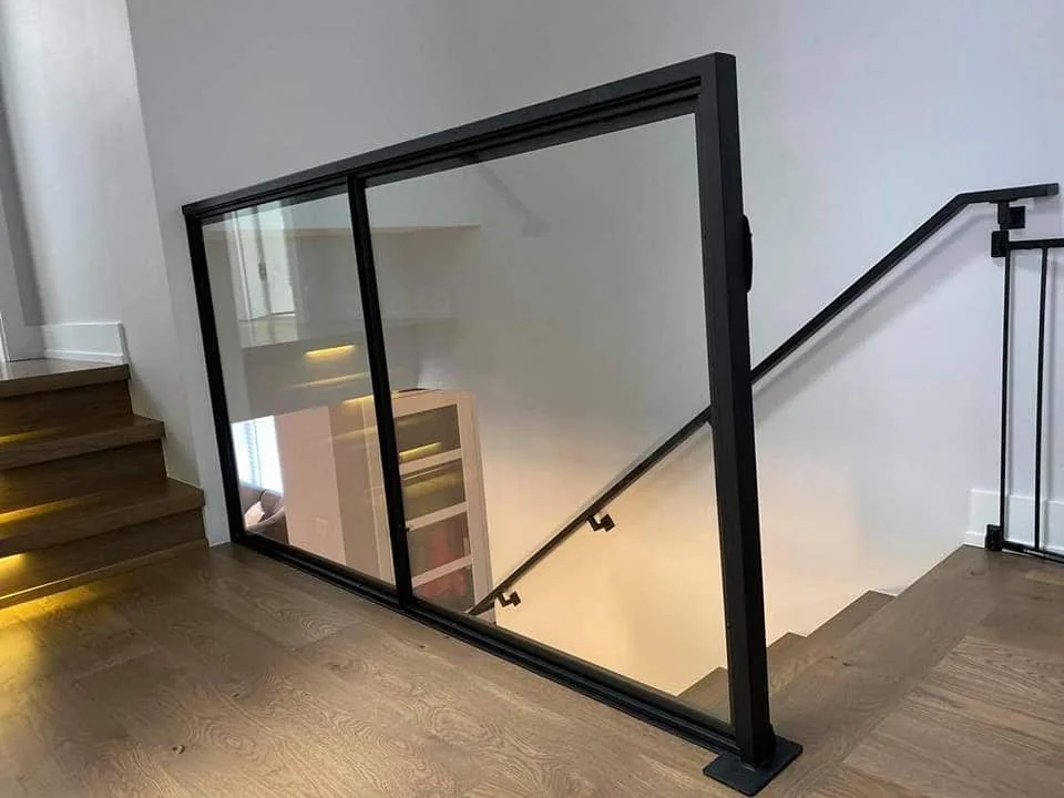 Upper landing glass railing in the Alpha Welding Services gallery