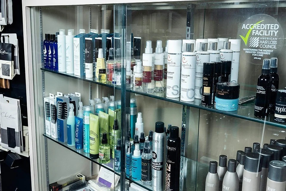 Styling product cabinet at Christine Pusateri Hair Solutions