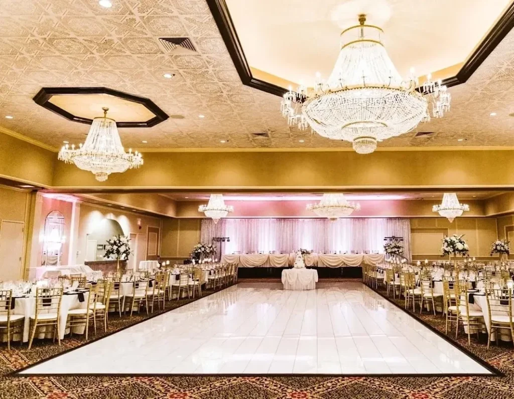Wide view of the ballroom dance floor beneath chandeliers; Cotillion Banquets gallery