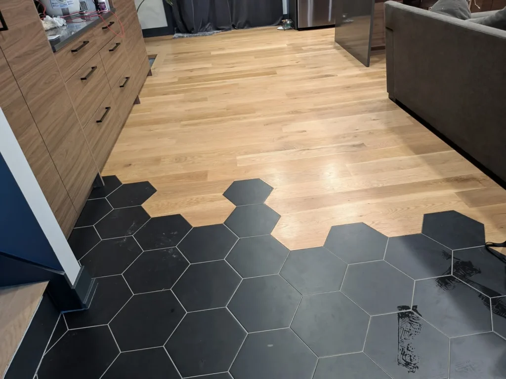 Wood floor hexagon tile transition in the DS Superior Hardwood Flooring gallery