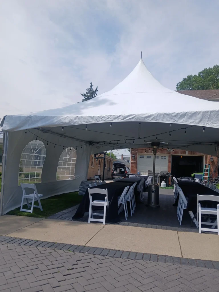 Backyard tent with sidewalls and chairs shown by Fiesta Party Rental