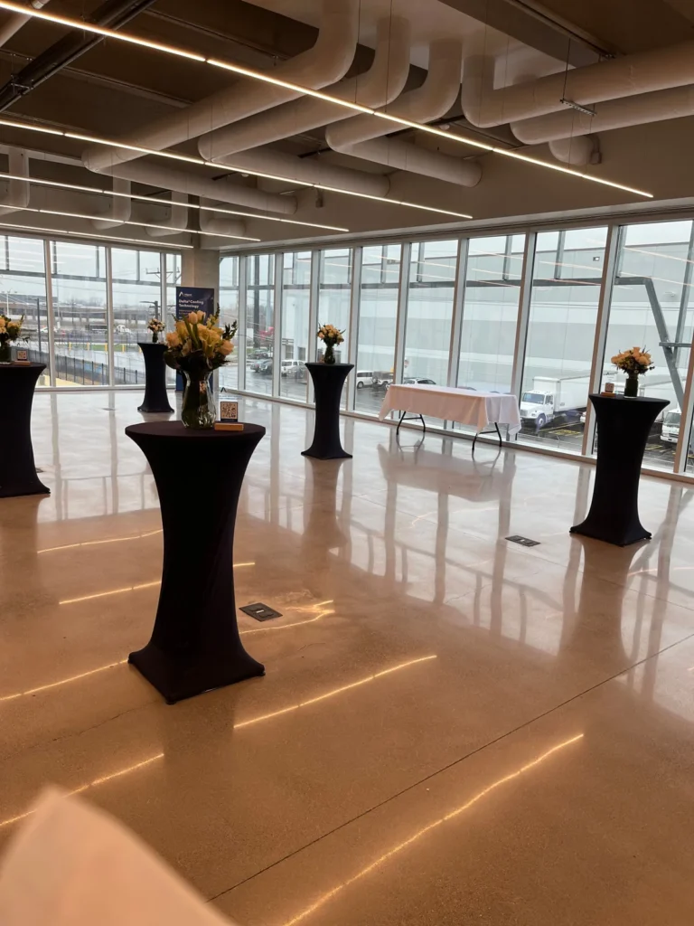 Cocktail tables in an event space shown by Fiesta Party Rental