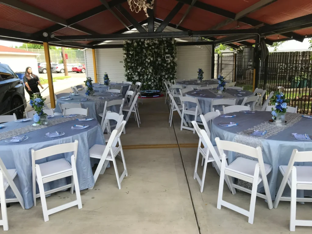 Outdoor dining setup with tables and folding chairs shown by Fiesta Party Rental