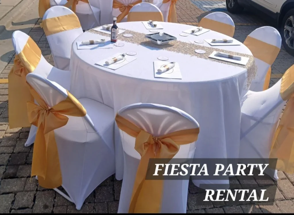 Round table and chairs with gold sashes shown by Fiesta Party Rental