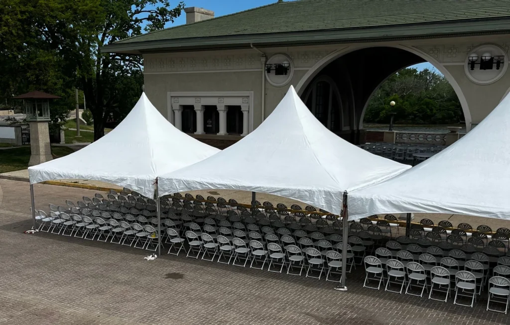 White event tents and rows of outdoor seating shown by Fiesta Party Rental