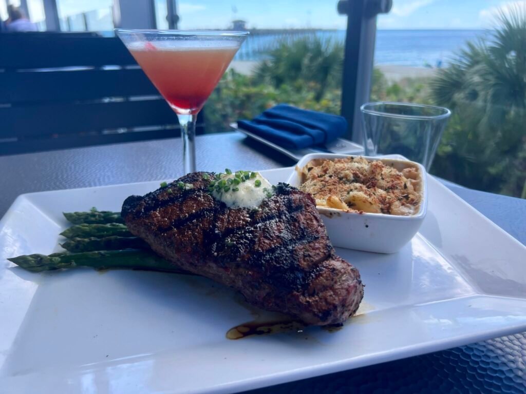 Grilled steak, side dish and cocktail on the terrace; Fins at Sharky's gallery