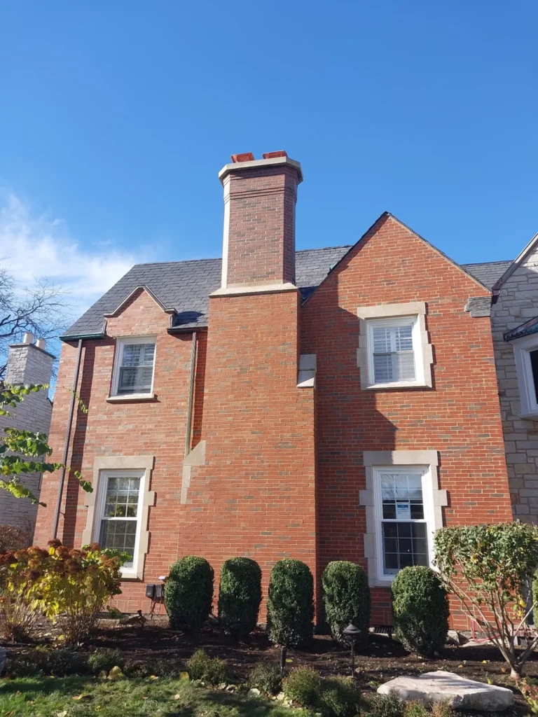 Brick house with an exterior chimney — Greg’s Restoration
