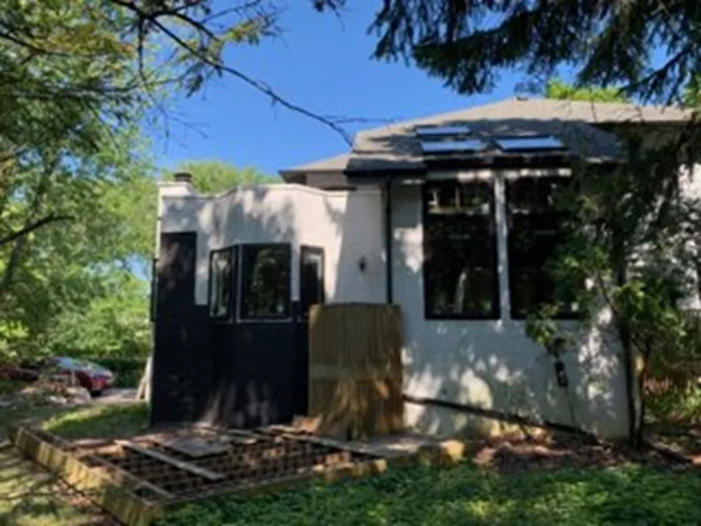 House wall before resurfacing shown by Illinois Stucco