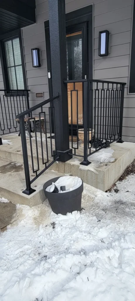 Black metal railing around front steps in the JG Welding gallery