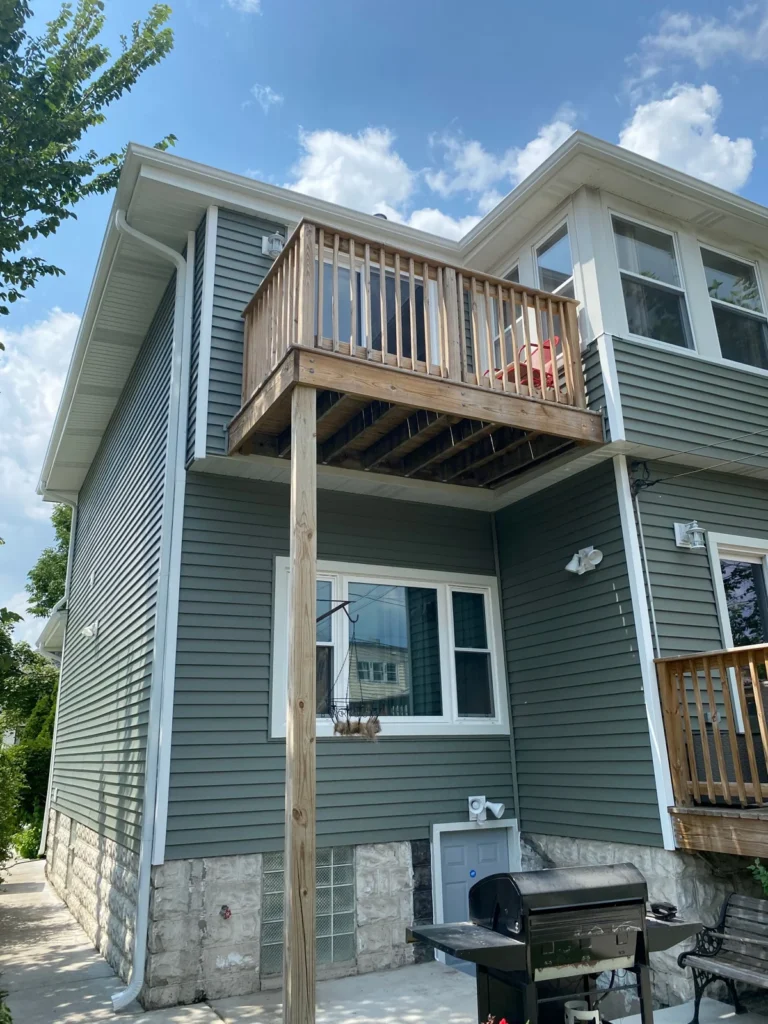 Rear deck gray siding in the Midwest Renovation Services gallery