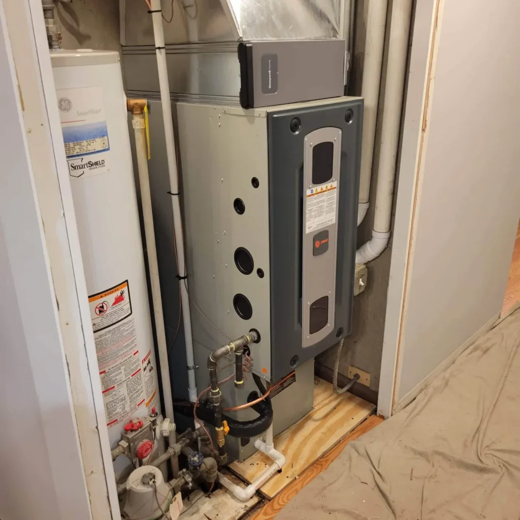 Furnace and connected ductwork in a utility room shown by Mr. Heating and Cooling