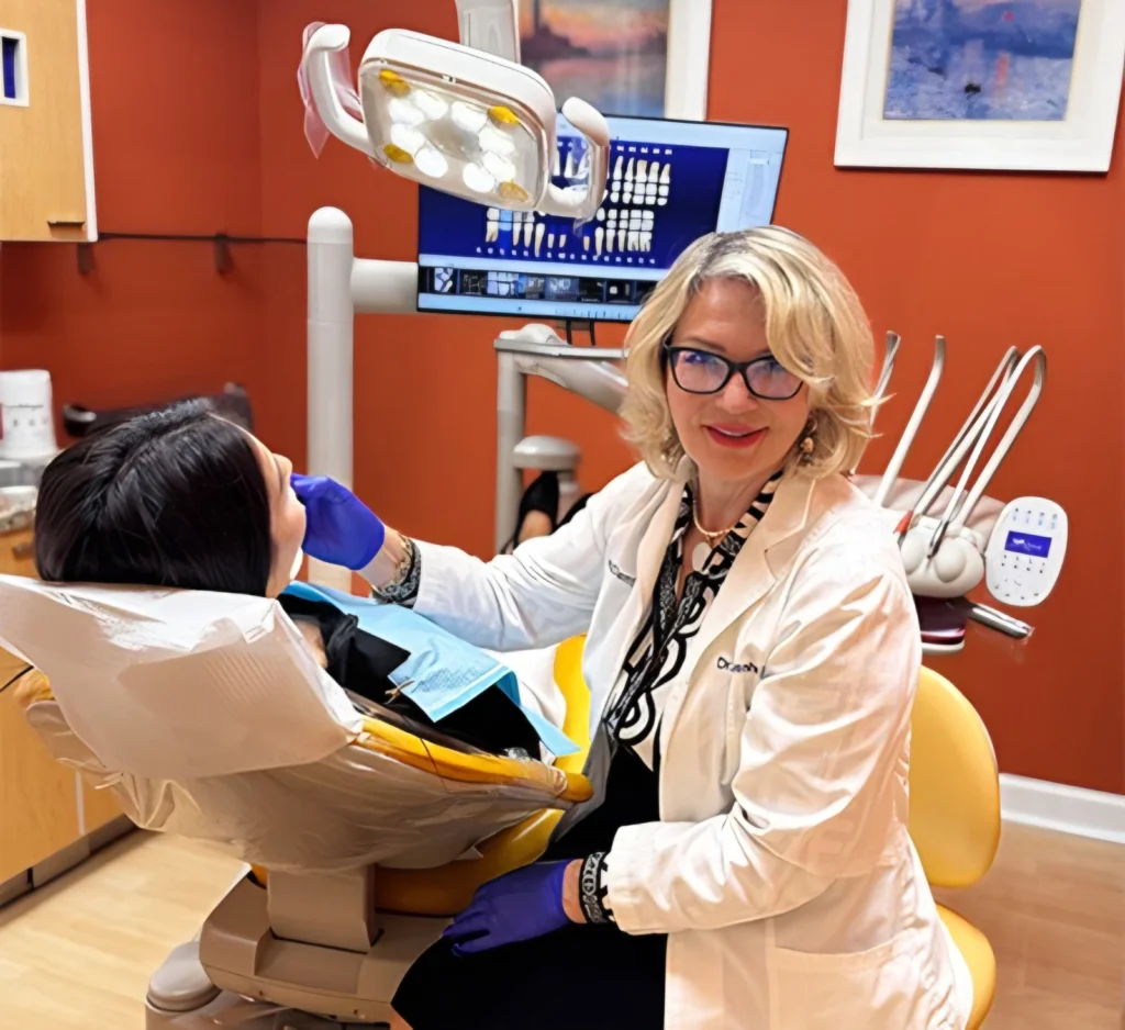 Dentist beside a patient chair in an OmDent treatment room