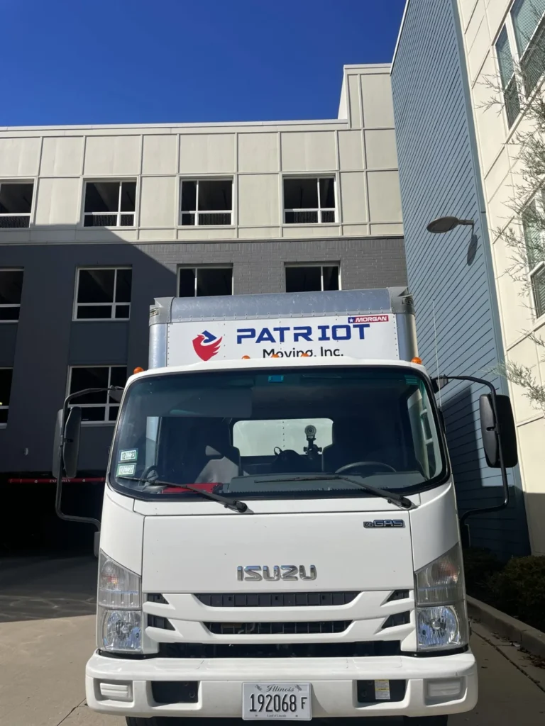 Patriot Moving truck parked outside a building entrance