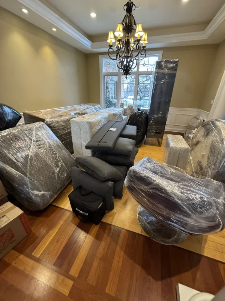 Patriot Moving wrapped chairs and furniture in a dining room