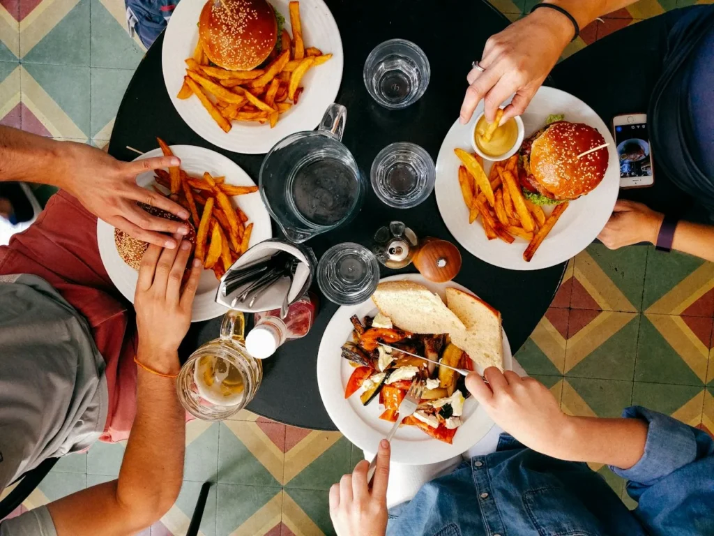 Burgers and fries shared around a dining table