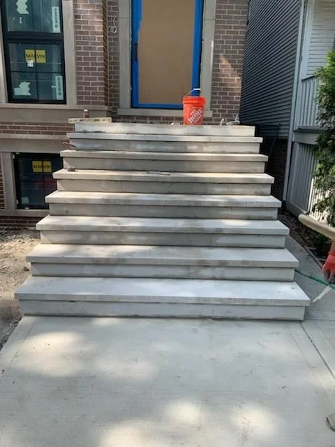 Stone entry stairway shown by ST Masonry Builders
