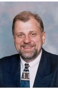 Tad Szmelter in a suit and patterned tie