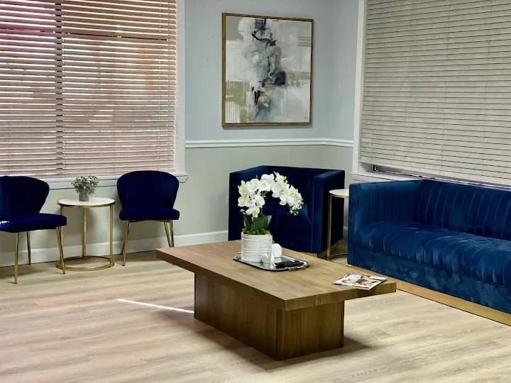 Waiting area with blue seating and side tables