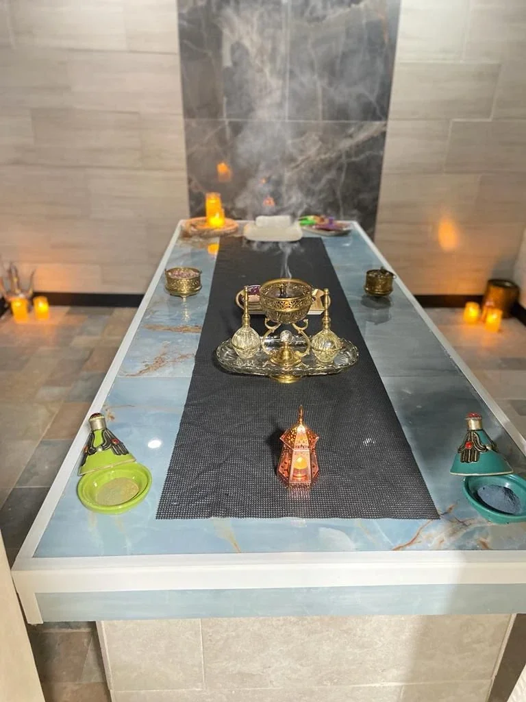 Stone treatment table with candles and tea
