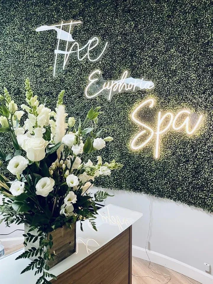 The Euphoria Spa illuminated reception sign and flowers