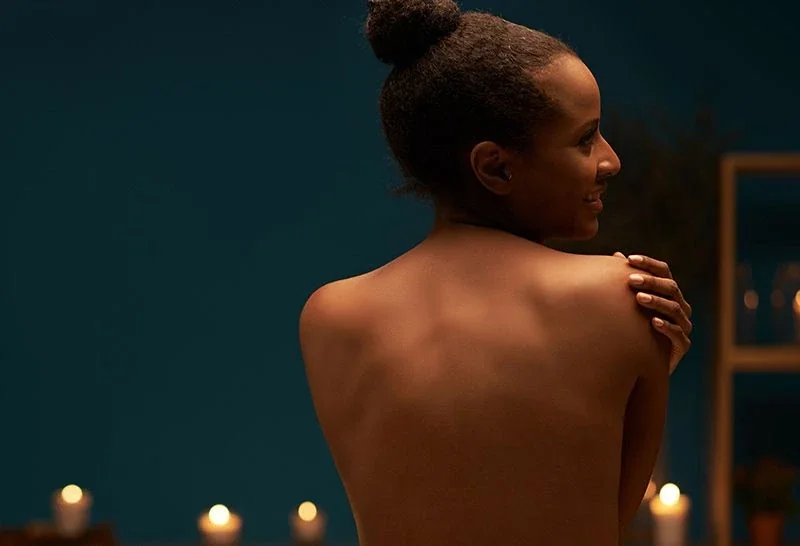 Promotional portrait of a woman in a spa setting