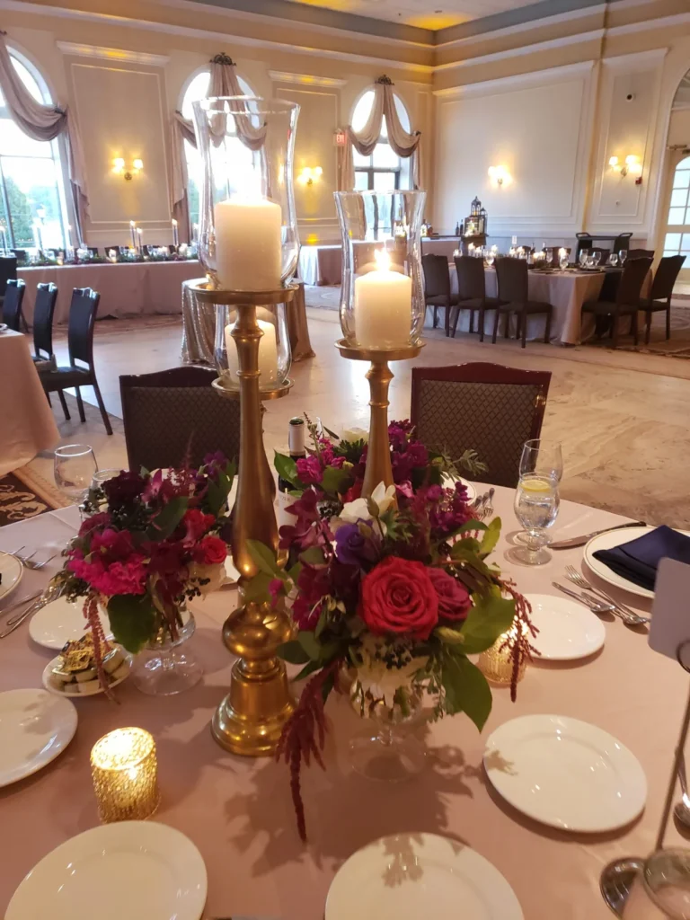 Floral candlestick centerpiece shown in the Venuti’s in Addison gallery